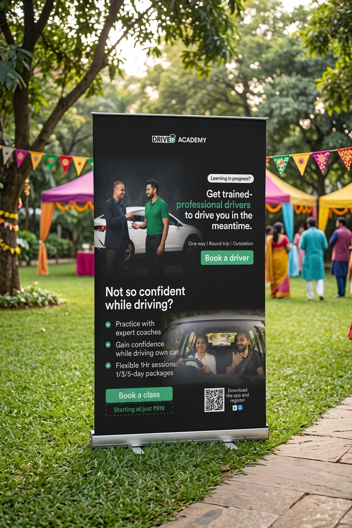 DriveU Academy standee at an outdoor event offering driving lessons with expert coaches from 519 rupees